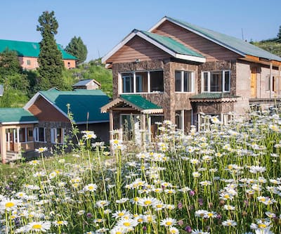 https://imgcld.yatra.com/ytimages/image/upload/t_hotel_yatra_city_desktop/v1409058565/Domestic Hotels/Hotels_Gulmarg/Hotel Nedous/Lupin_outside_copy.jpg